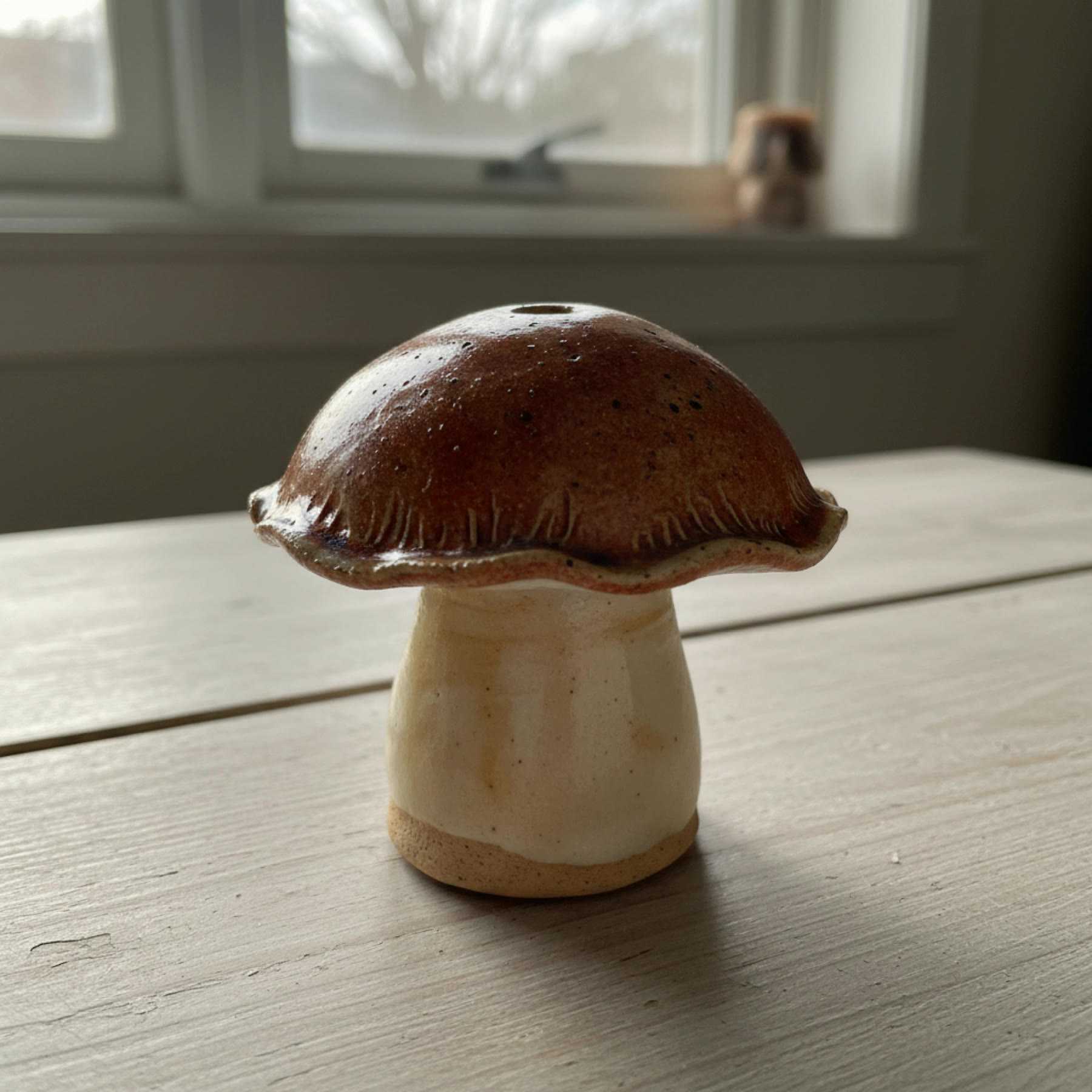 Illustration of a mushroom-shaped ceramic incense holder with a brown cap