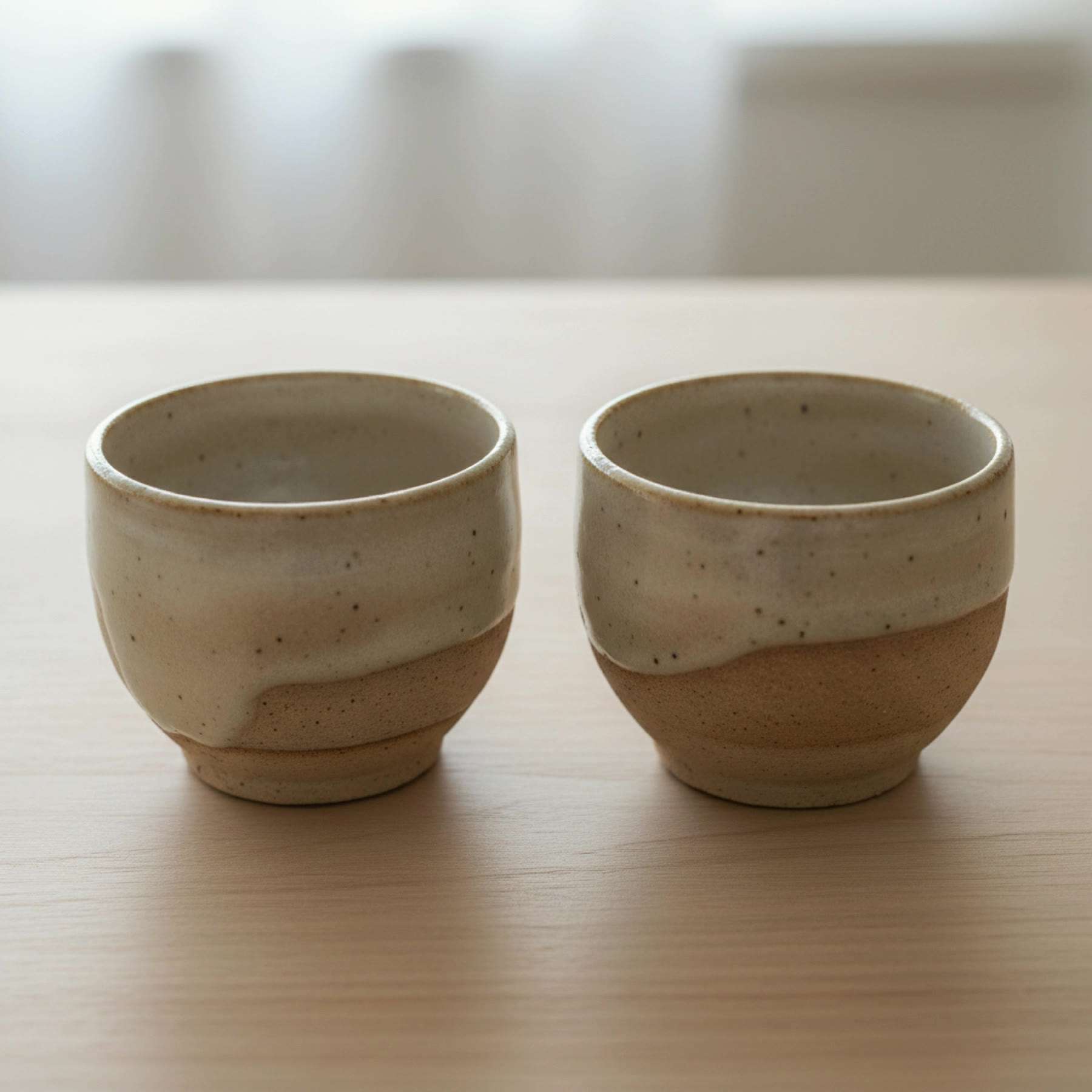 Illustration of two empty pinch-pot chai cups, glazed inside