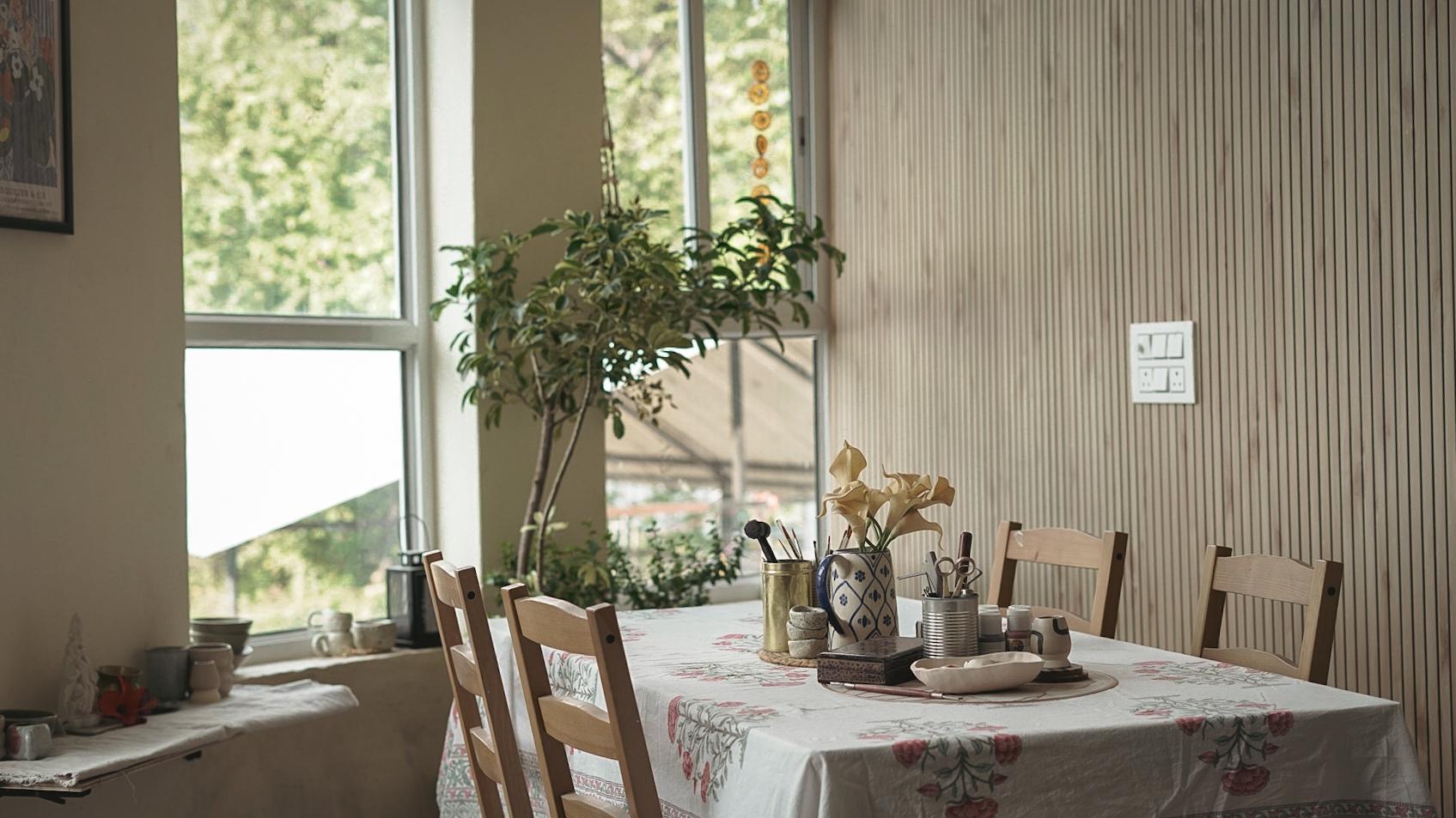 Studio workspace with floral tablecloth and natural light