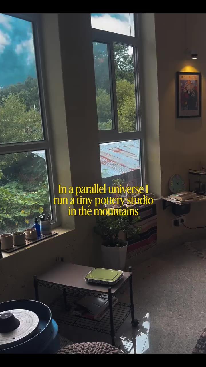 The studio's windows onto the valley, monsoon cloud over the ridge, and a leaf pressed into a clay dish