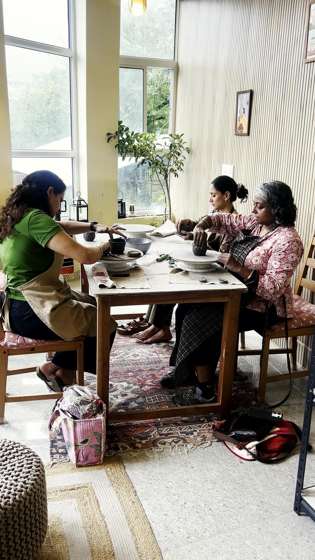 Tools, boards and half-made pieces spread across the studio's working table