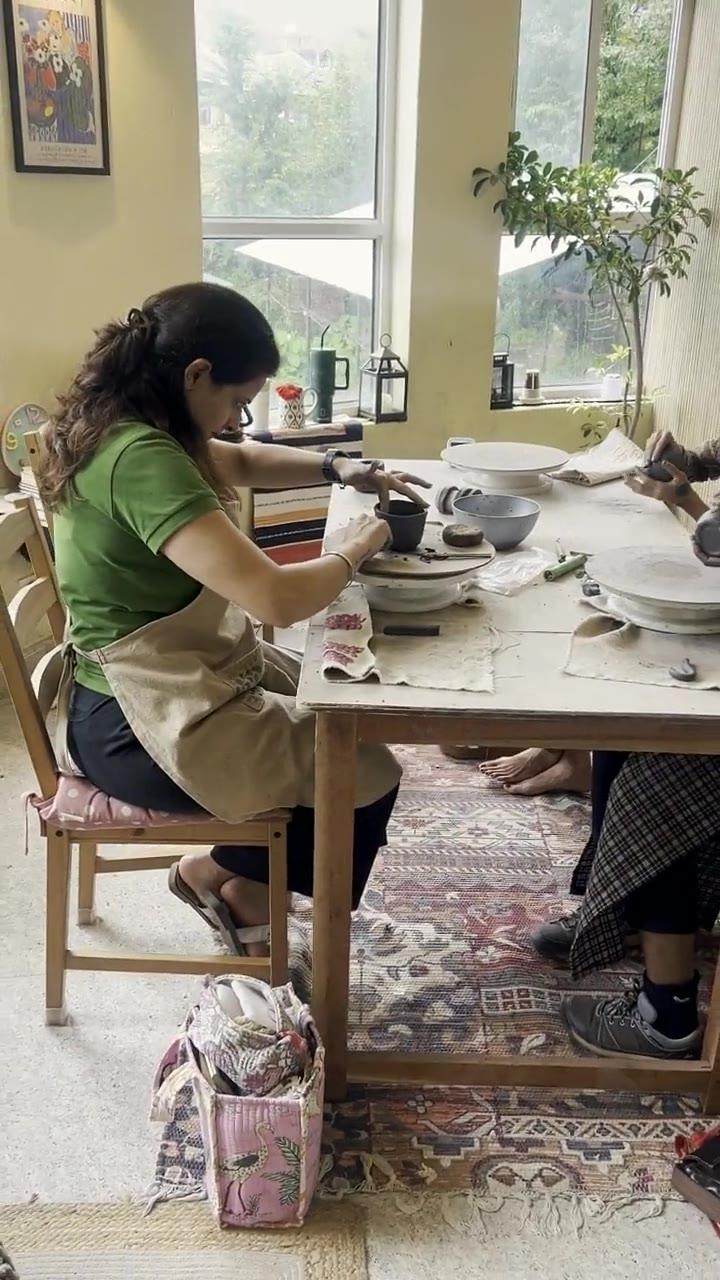 The long studio table seen down its length, work in progress along it