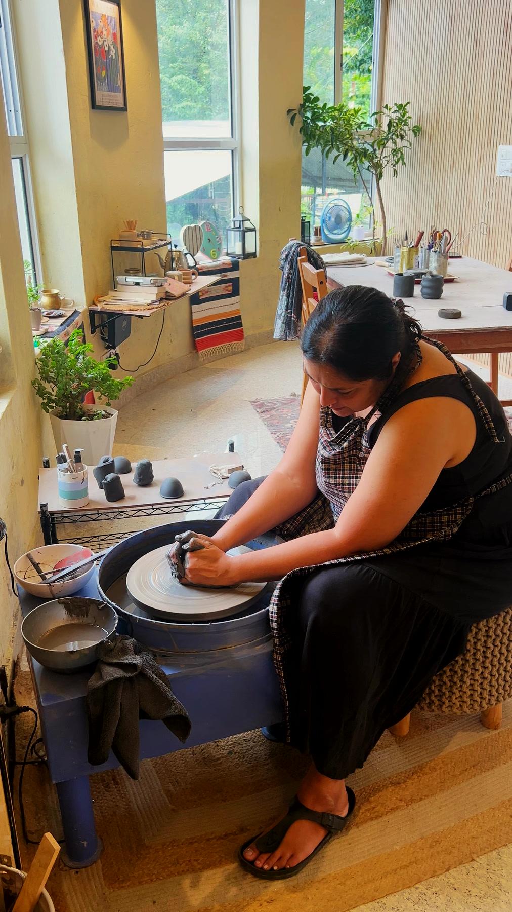 A guest seated at the wheel, both hands closed around a spinning cylinder