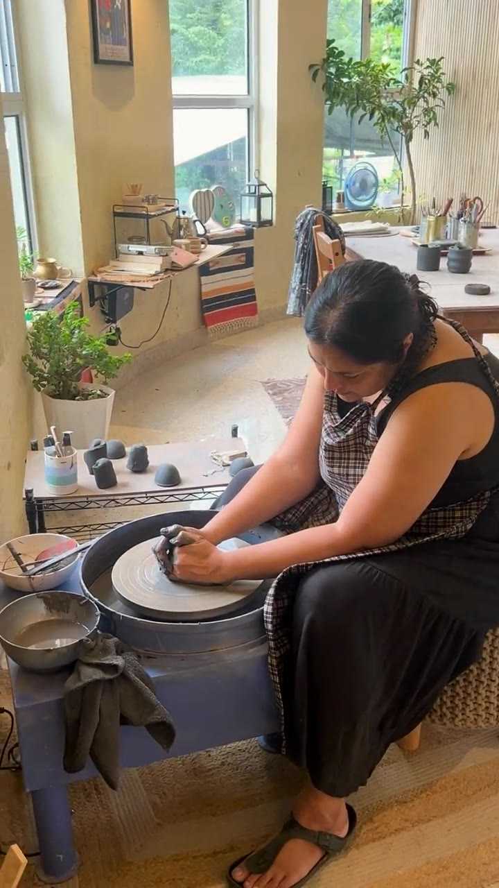 A guest seated at the wheel, both hands closed around a spinning cylinder