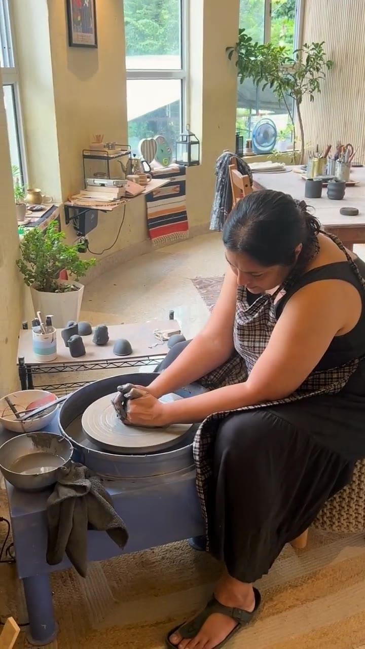 A guest seated at the wheel, both hands closed around a spinning cylinder